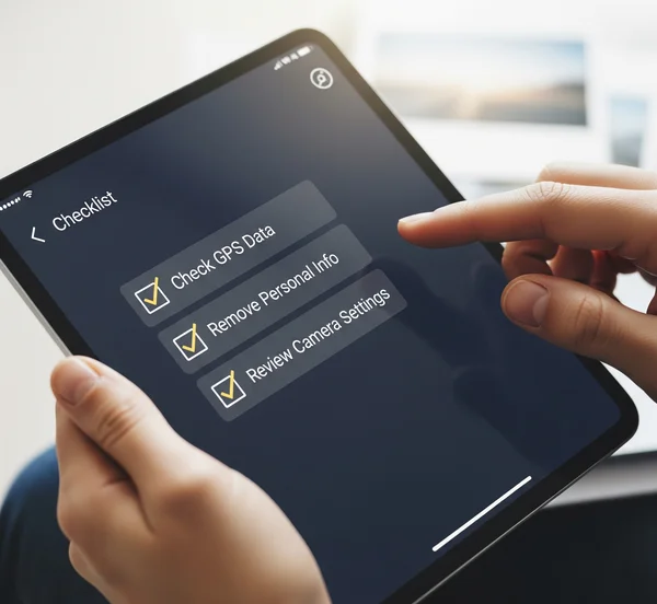 Person reviewing a digital checklist for photo metadata management